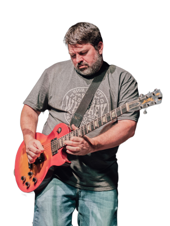 Travis playing a Les Paul guitar